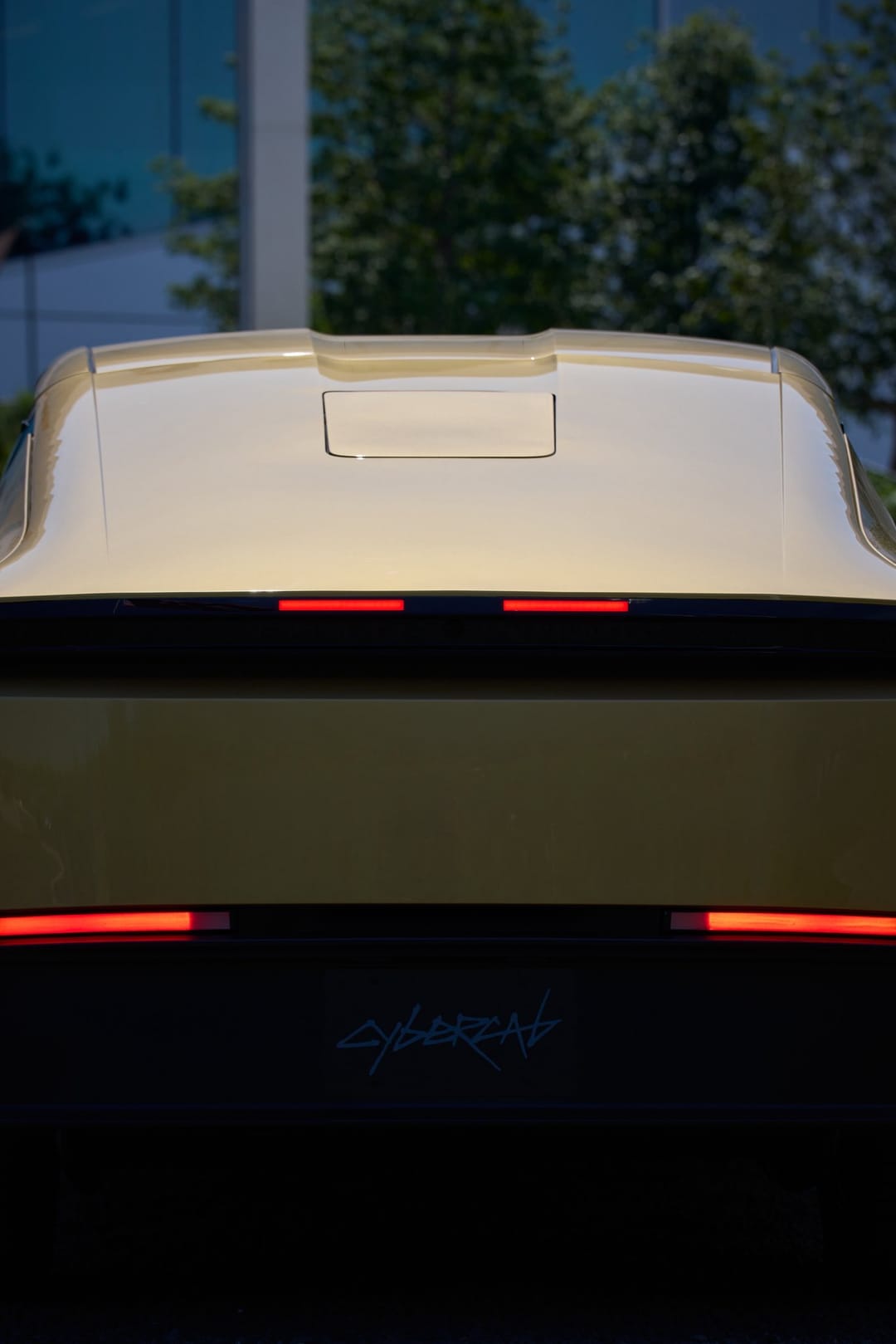 Rear of a gold Cybercab with its light bar