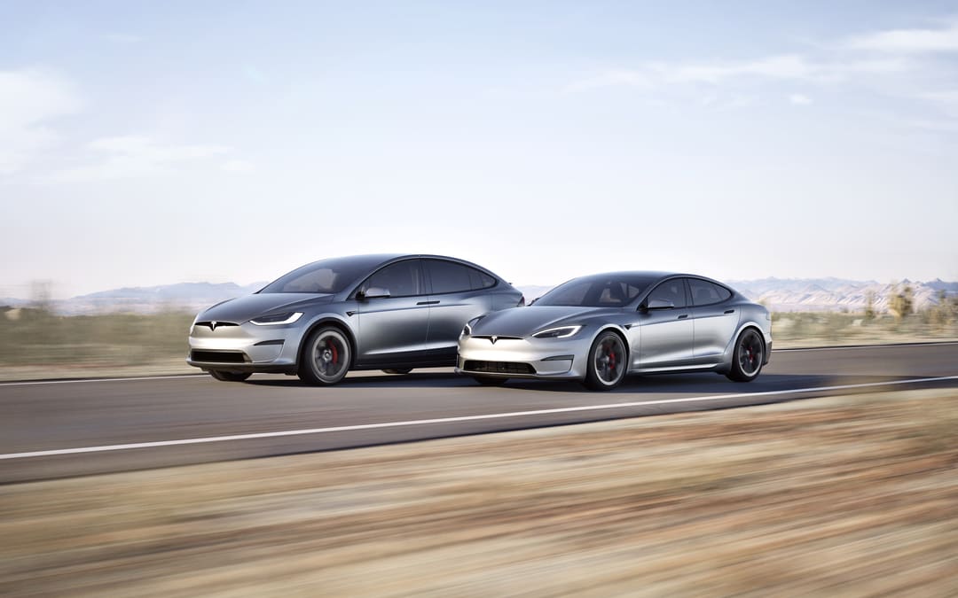 Silver Model X and Model S driving side by side