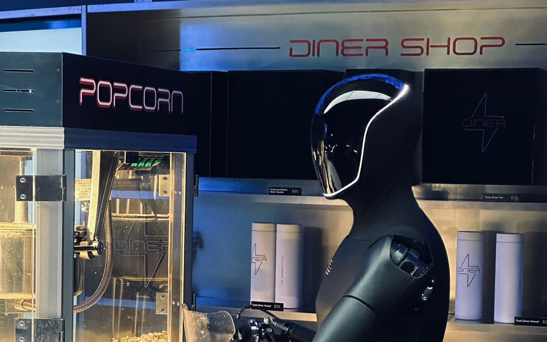 Optimus working at a popcorn counter (Tesla Optimus “Back to work” Tesla Diner post)