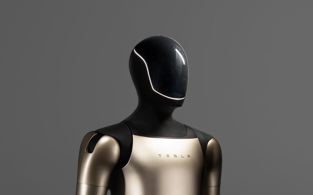 Tesla Optimus humanoid robot against a grey studio backdrop